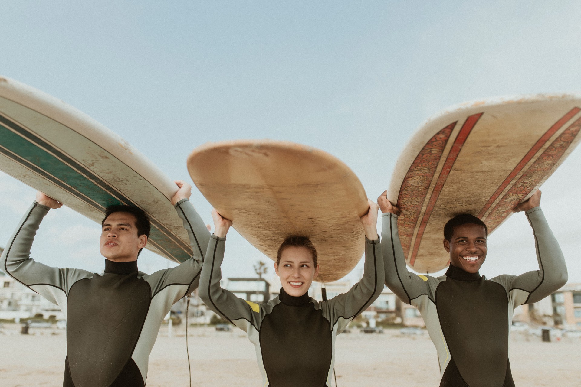 Happy friends surfing at the beach